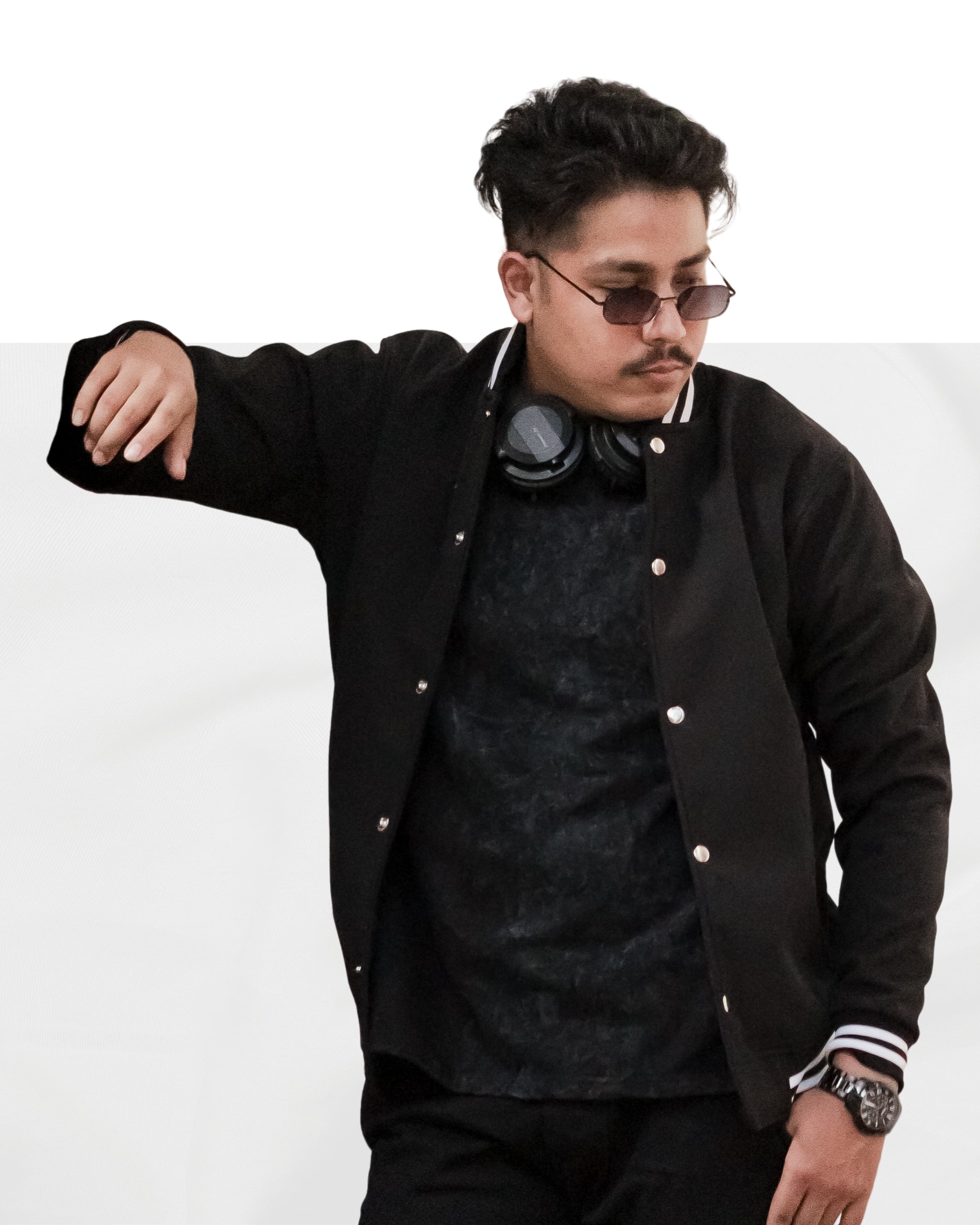 Man wearing a black jacket with white buttons on a white background