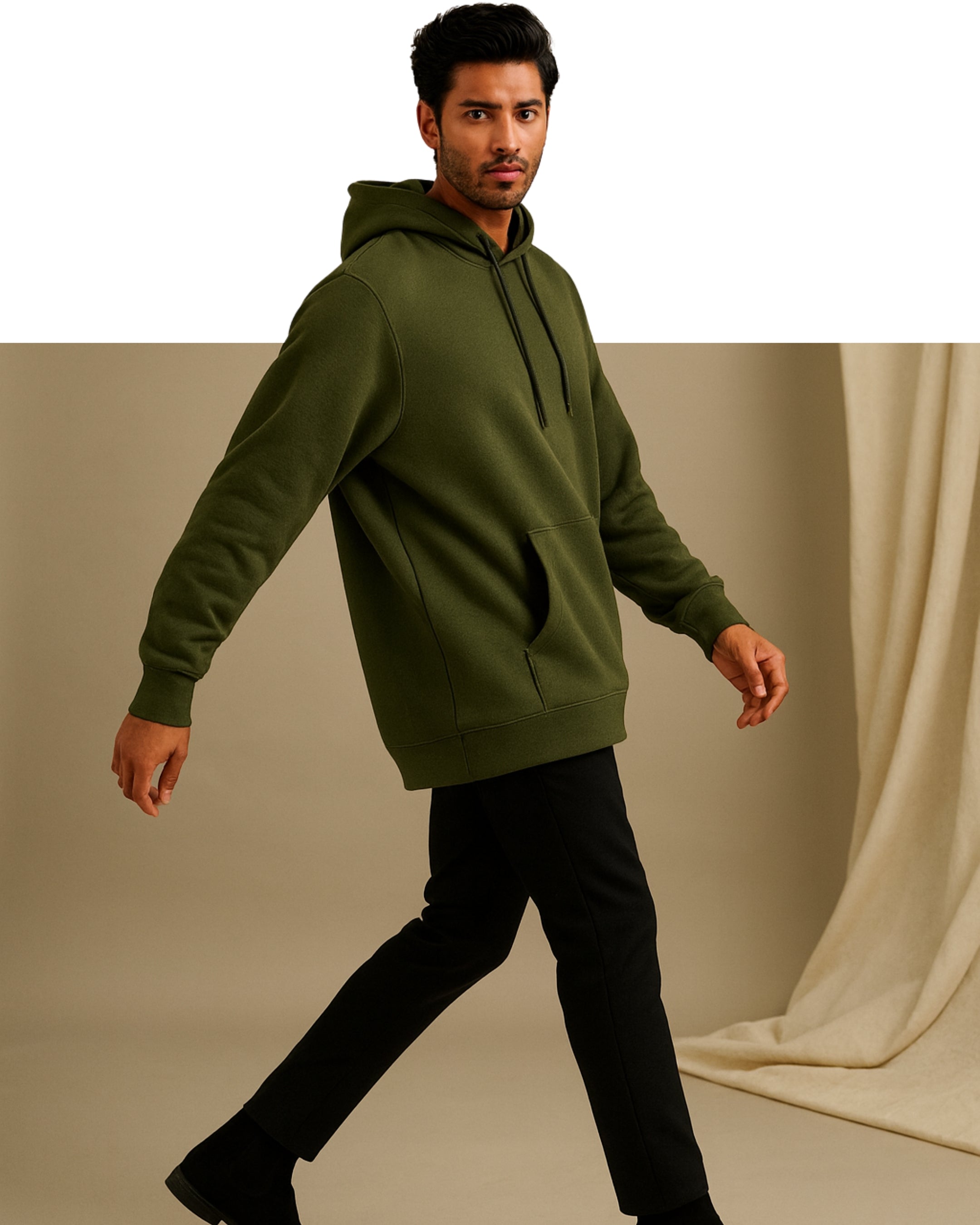 Man wearing a green hoodie against a neutral background