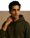 Man wearing a dark green hoodie against a beige background