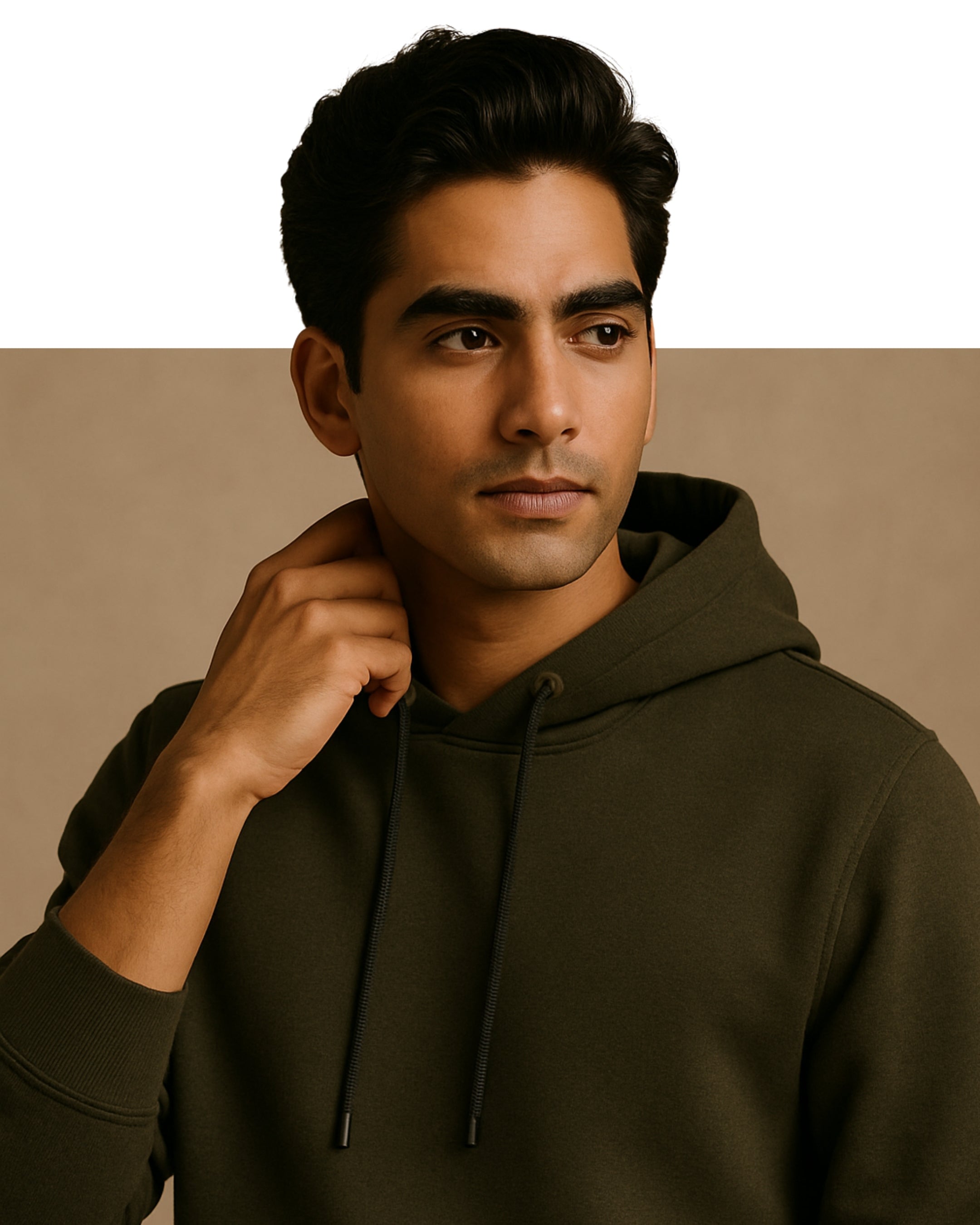 Man wearing a dark green hoodie against a beige background