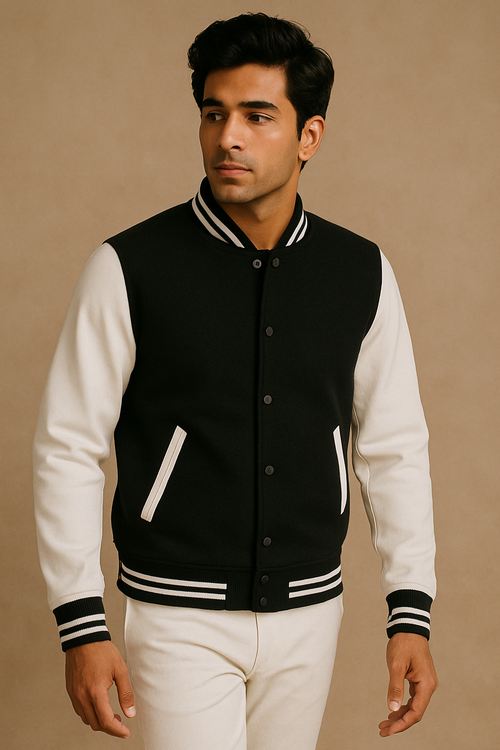 Man wearing a black and white varsity jacket on a beige background