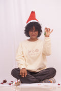 Person wearing a Santa hat and a white sweatshirt with text, sitting on a white background.