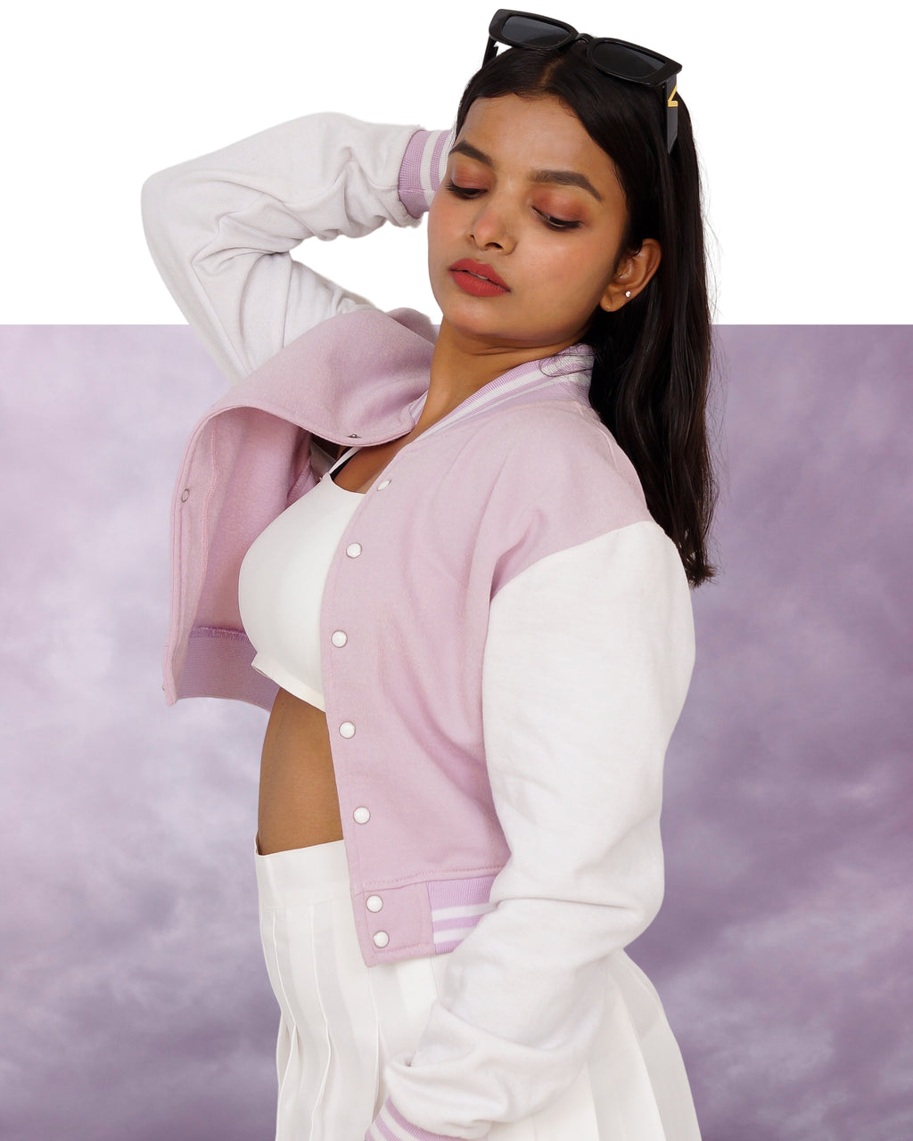 Woman wearing a Lavender and white jacket against a purple background