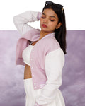 Woman wearing a Lavender and white jacket against a purple background