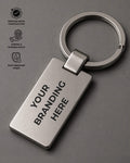 Metal keychain with 'Your Branding Here' text on a gray background