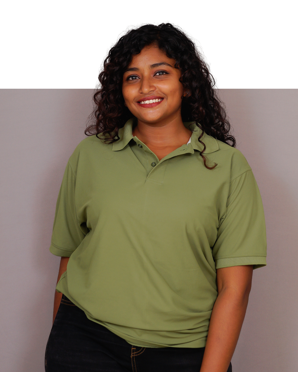 Woman wearing a green polo shirt against a plain background