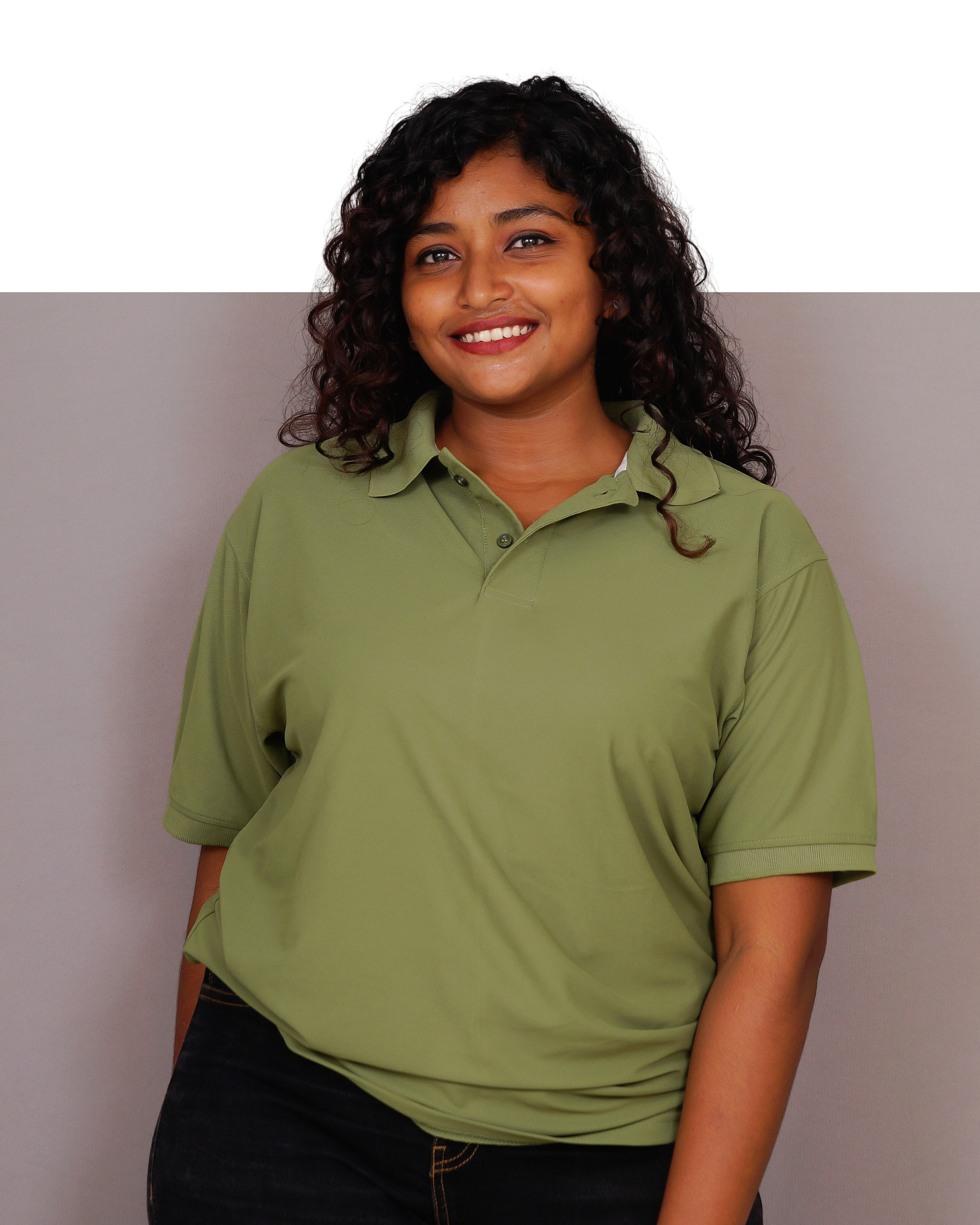 Woman wearing a green polo shirt against a plain background