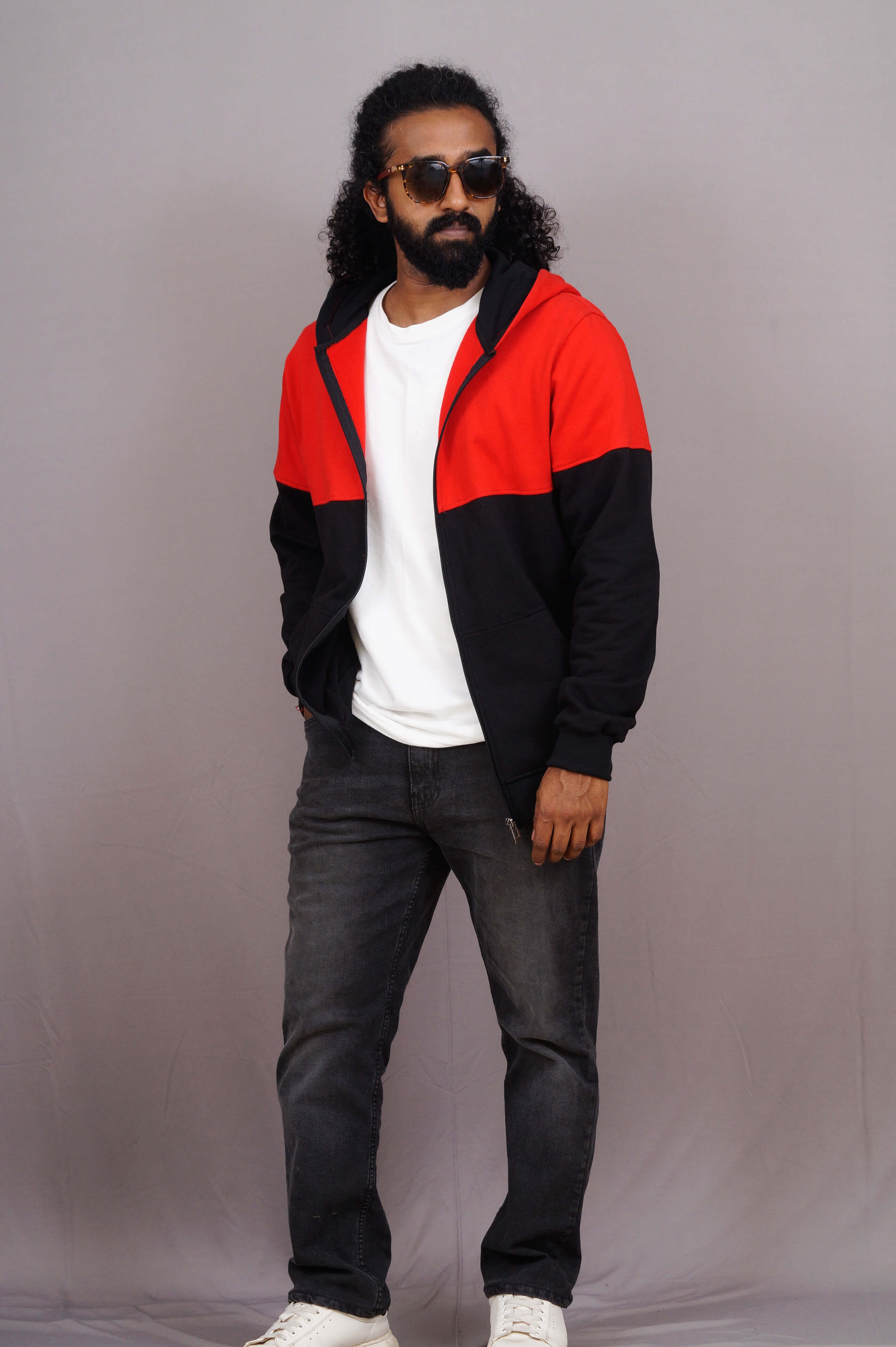 Man wearing a red and black jacket with a plain background