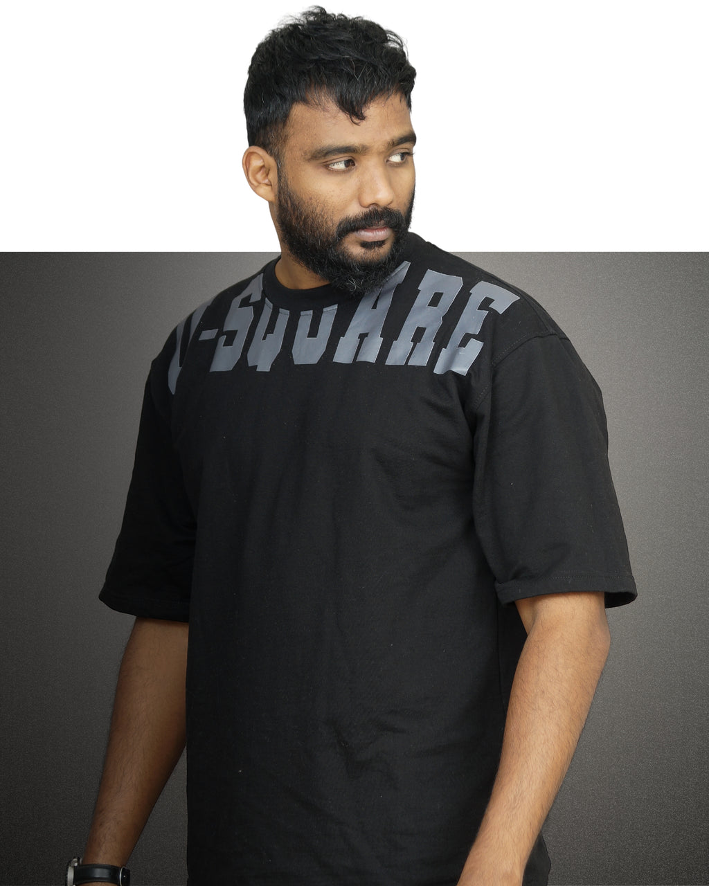 Man wearing a black t-shirt with 'V-Square' branding against a gray background