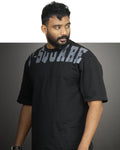 Man wearing a black t-shirt with 'V-Square' branding against a gray background