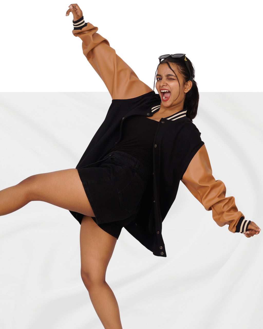 Woman wearing a black dress with brown sleeves on a white background