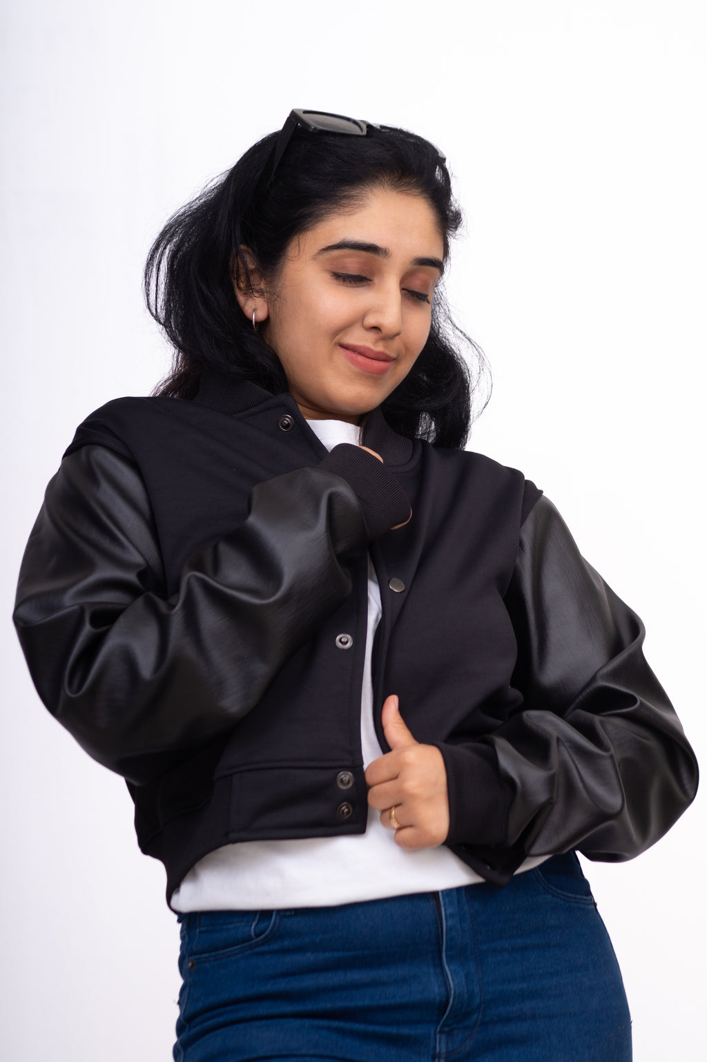 Woman wearing a black jacket with a white background