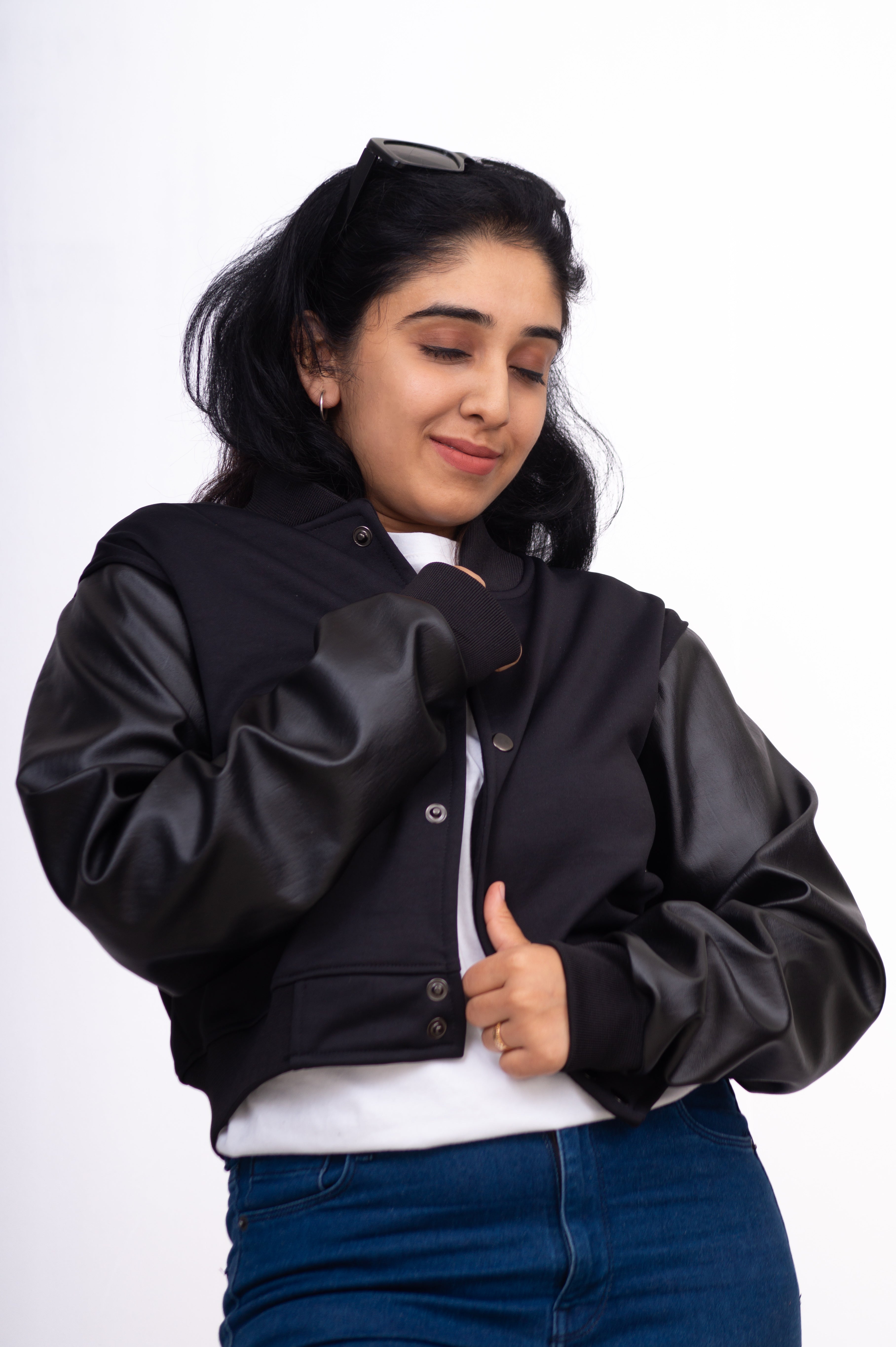 Woman wearing a black jacket with a white background